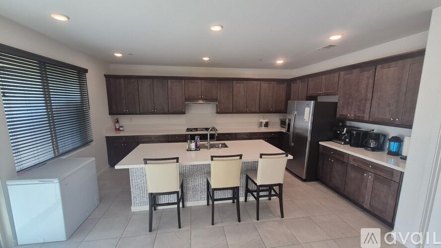 A kitchen with a table and chairs in the middle of the room.