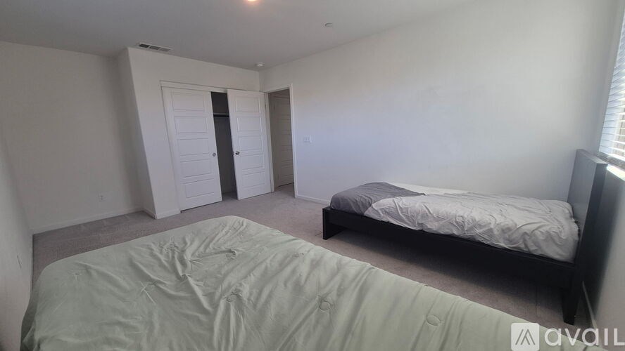 A bedroom with a bed, dresser, and closet.