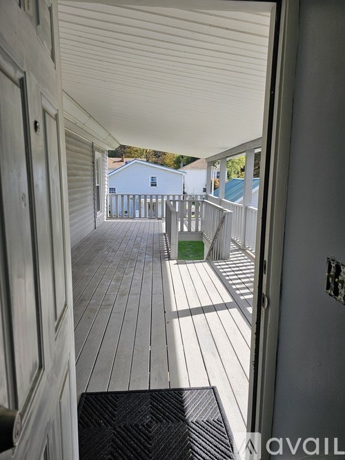 A view from inside a house looking out to a deck.