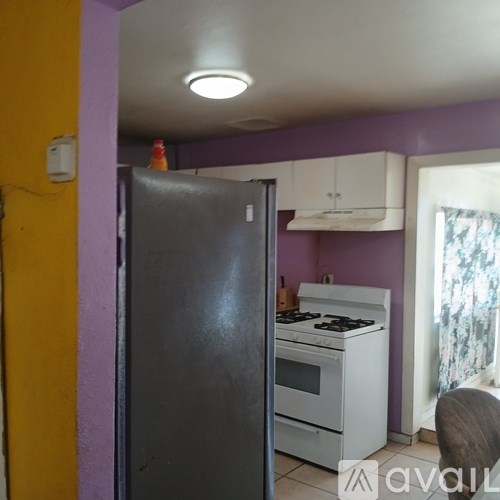 A kitchen with a refrigerator, stove, and oven.