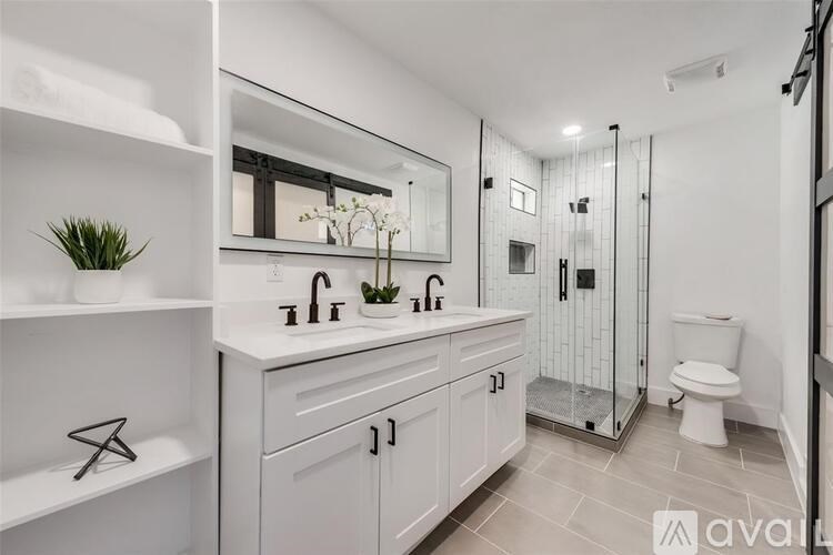 A bathroom with a white sink and a walk-in shower.