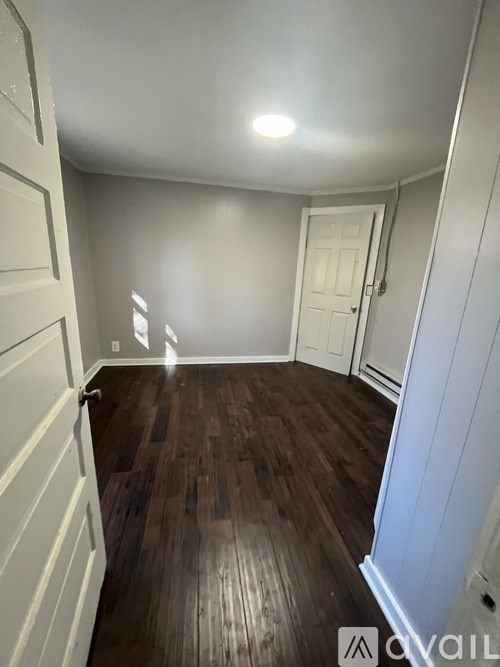 A room with wooden floors and white walls.