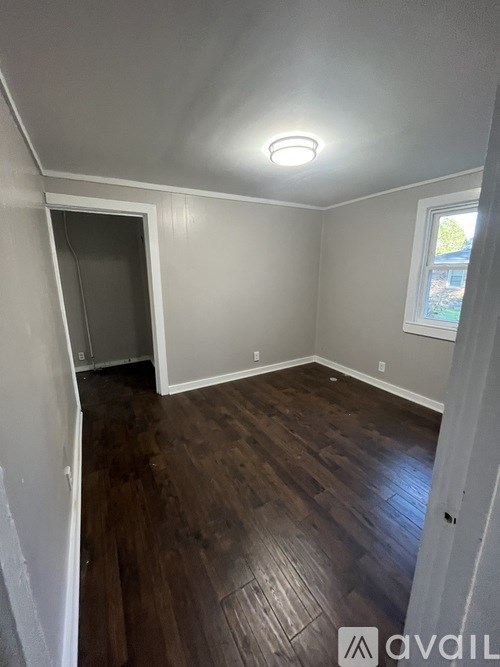 A room with wooden floors and a window.