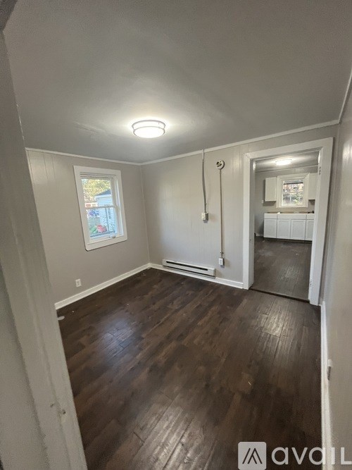 A room with wooden floors and a window.