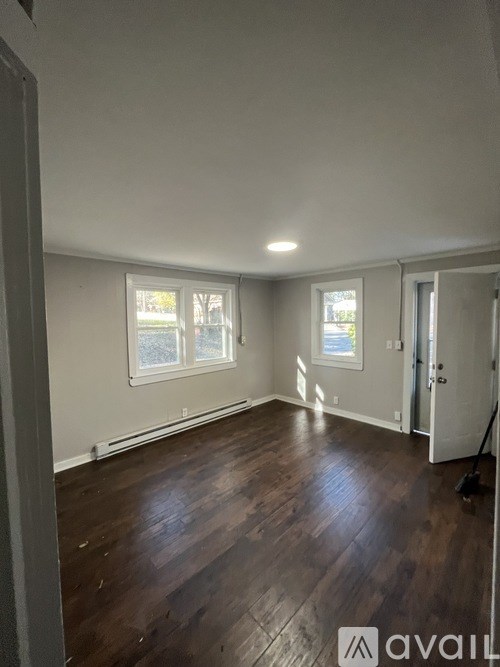 A room with wooden floors and white walls.