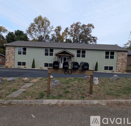 A house with the number 60 on a sign in front of it.