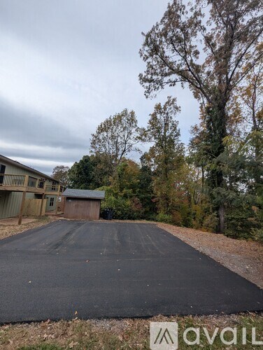 A blacktop driveway leads to a garage.
