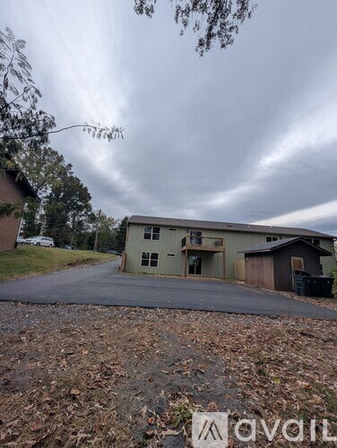A large building with a driveway in front of it.