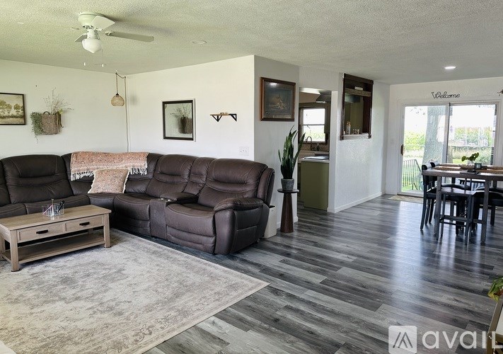 A living room with a brown leather couch and a wooden coffee table.