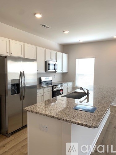 A kitchen with granite countertops and stainless steel appliances.