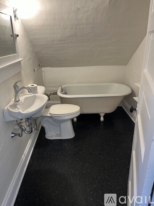 A white toilet and sink in a small bathroom.