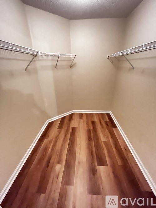 A room with a wooden floor and white walls.