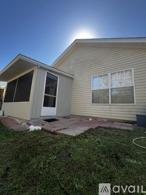 A house with a sunny sky in the background.