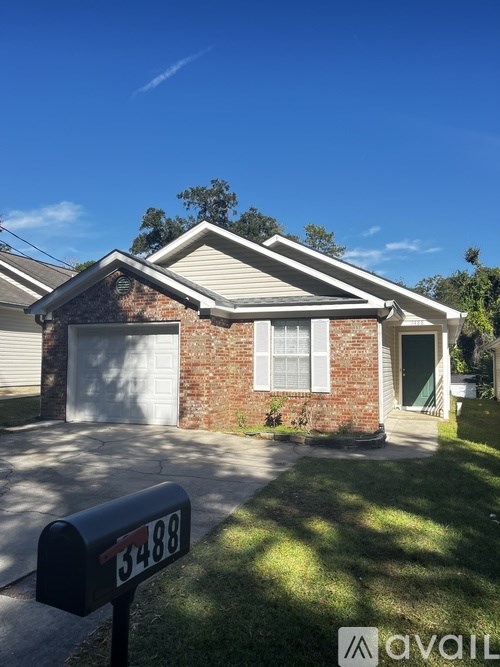 A house with a black mailbox that has the number 3488 on it.