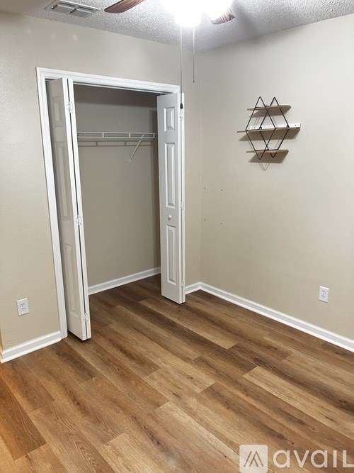A room with a wooden floor and a white door.