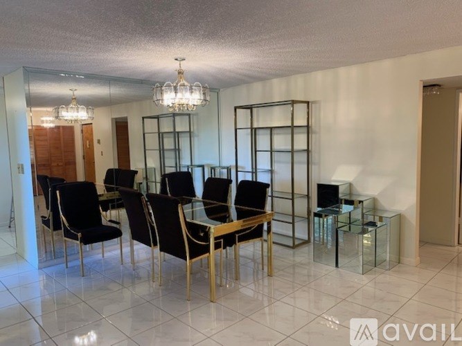 A room with a glass table and chairs.