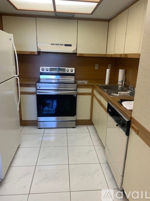 A kitchen with a white fridge, stove, and oven.
