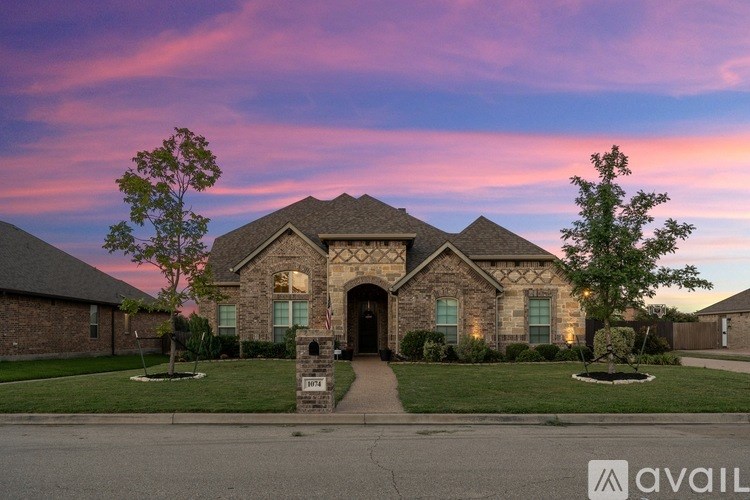 A house with a flag on the front porch is available for sale.