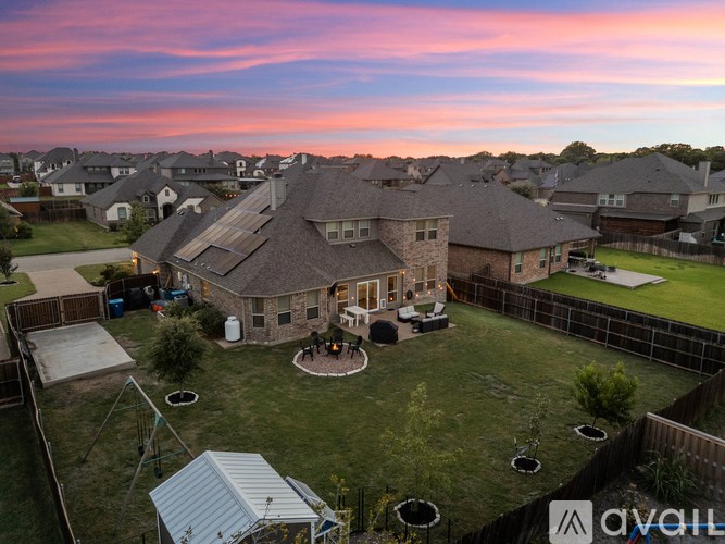 A house with a large backyard and a patio area.