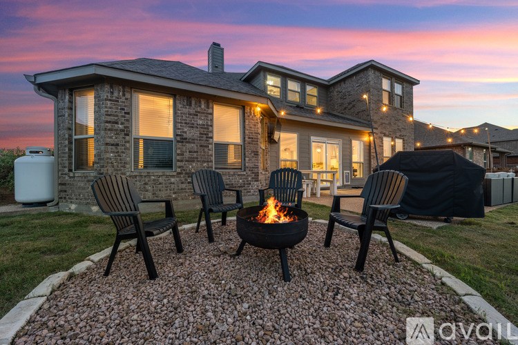 A house with a fire pit in front of it.