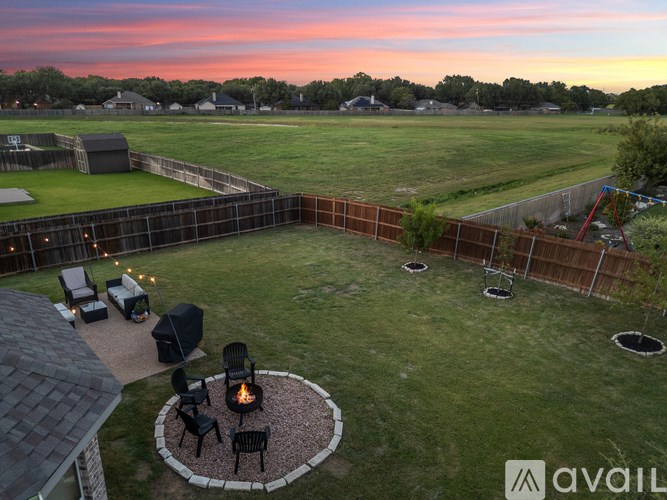 A backyard with a fire pit and seating area.