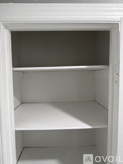 A white open cabinet with three shelves.