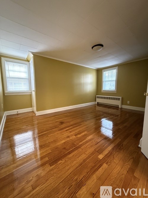 A room with wooden floors and a window.
