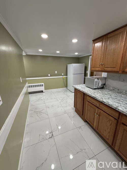 A kitchen with green walls and white appliances.