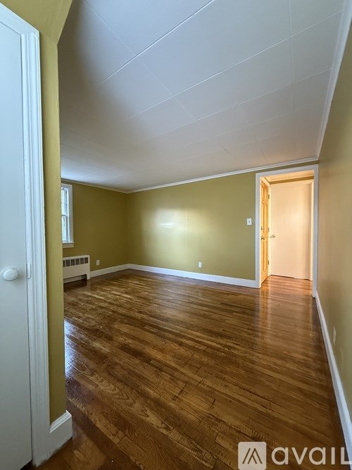 A room with wooden floors and a white door.