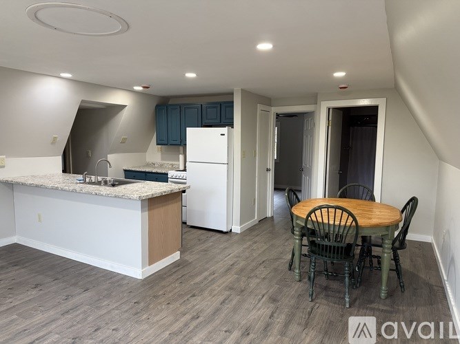 A kitchen with a table and chairs in the middle of the room.