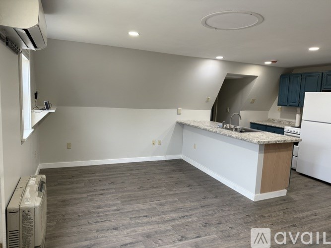 A kitchen with a white counter and a white refrigerator.