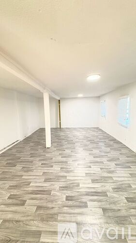 A room with a wooden floor and white walls.