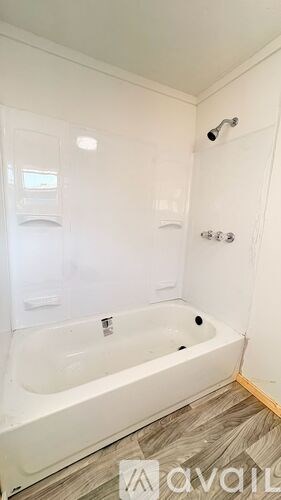 A white bathroom with a bathtub and a shower.