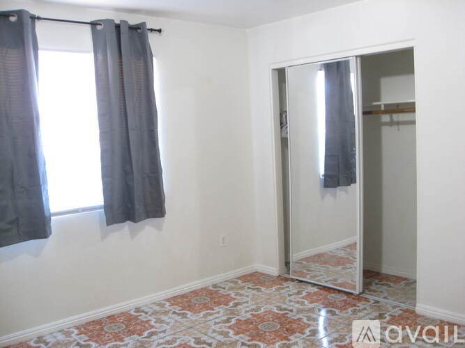 A room with a patterned floor and a glass door.