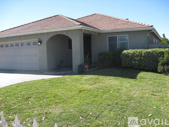 A house with a red roof and a garage.
