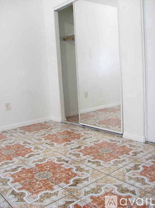 A room with a tiled floor and a large mirror.