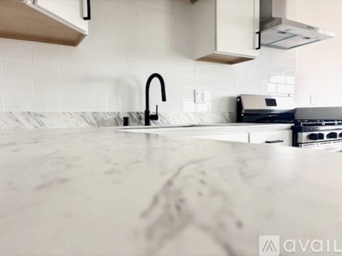 A kitchen counter with a sink and a stove top oven.