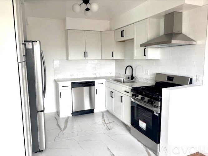 A kitchen with a refrigerator, stove, and dishwasher.