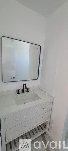 A bathroom with a sink and a mirror.