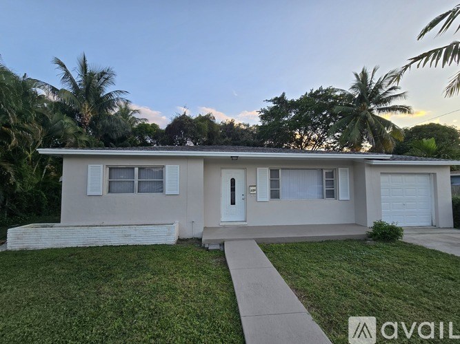 A house with a white garage door is for sale.