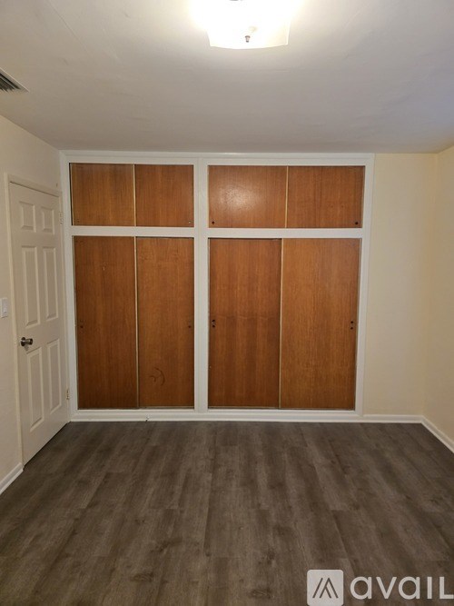 A room with wooden floors and a white door.