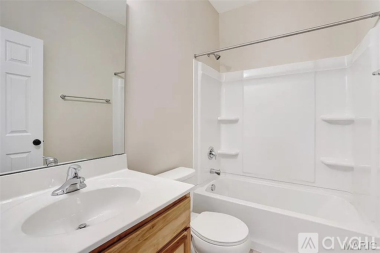 A white bathroom with a sink, toilet, and bathtub.