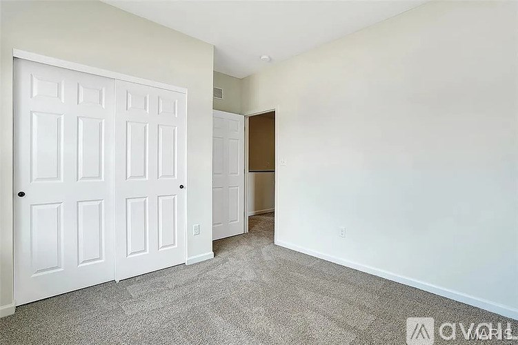 A white door with a black handle is on the left side of the image.