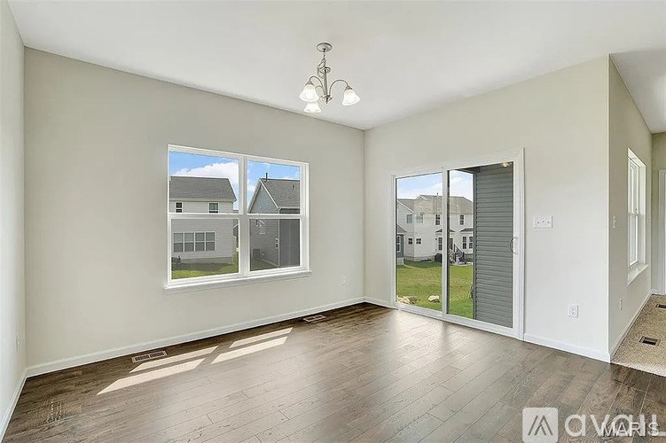 A room with a large window and a sliding glass door.
