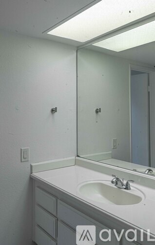 A bathroom with a sink and mirror.