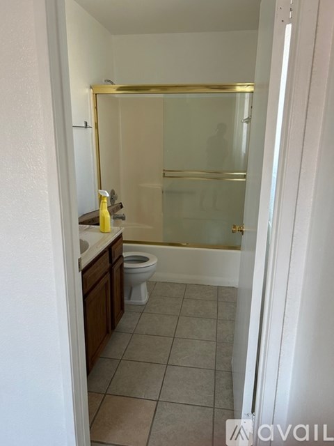 A bathroom with a toilet, sink, and shower.