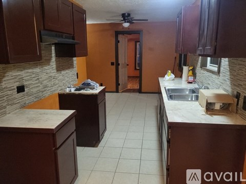 A kitchen with brown cabinets and a white countertop.