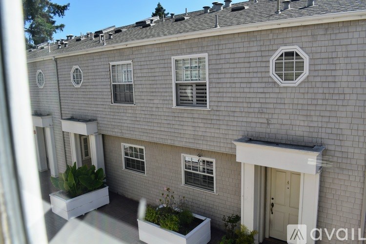 A grey building with white windows and doors.