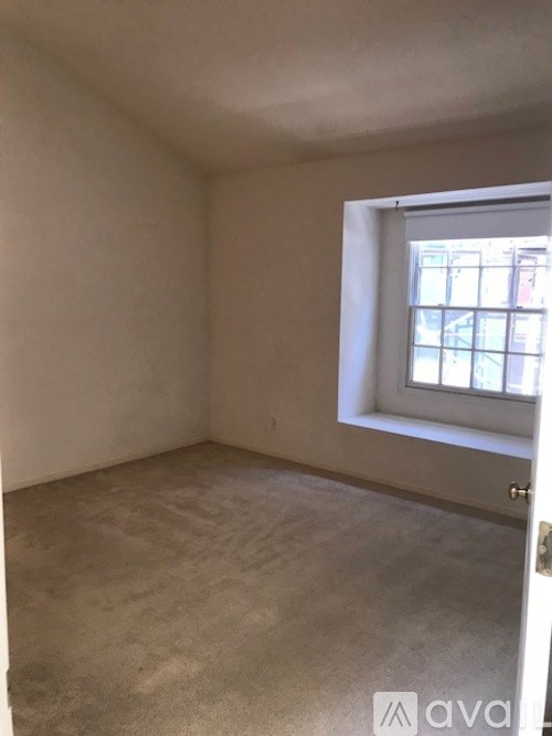 A room with a window and a door.