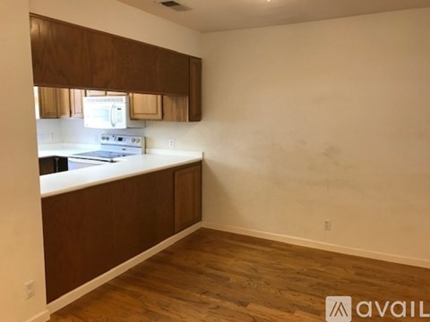 A kitchen with wooden cabinets and a white countertop.